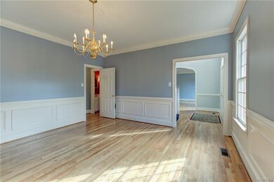 The spacious dining room showcases handsome wainsc