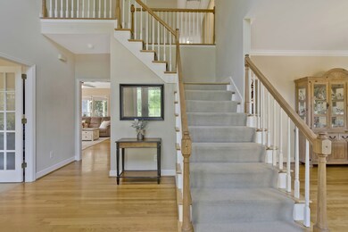 Large foyer with dual staircases