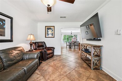 Cozy living area with neutral tones, crown molding