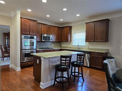 Chef-style kitchen with granite island and double ovens. Perfect for entertaining