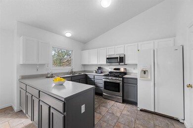 White upper and soft grey base cabinets with roll-