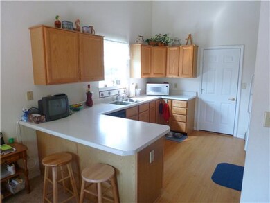 Kitchen. This kitchen has a breakfast bar and is bright and cheery......