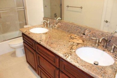 Granite counters and tile floors adorn full bath d