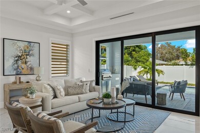 Living room with coffered ceiling, ceiling fan, an