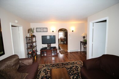 Main level living room leading to kitchen and dini