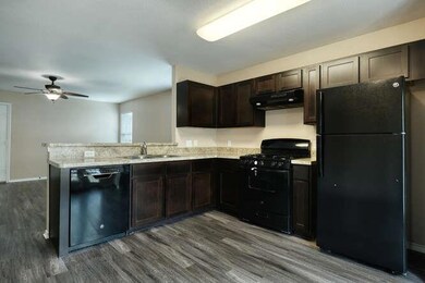 Kitchen with black appliances, ventilation hood, 