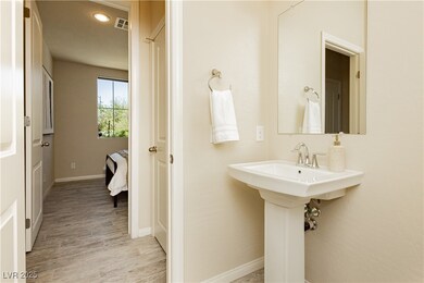 Bathroom with wood finished floors and baseboards