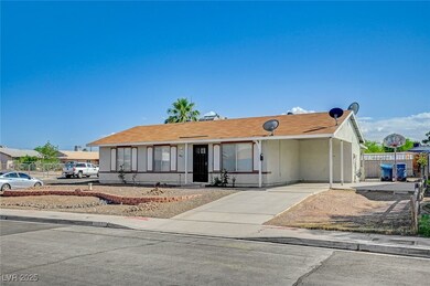 Ranch-style home featuring a carport and driveway