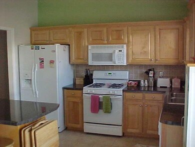 Awesome Kitchen with tons of cabinets and granite look countertops.