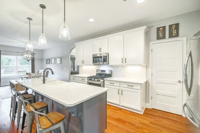 Gorgeous kitchen with quartz countertops, subway tile backsplash and large pantry. 