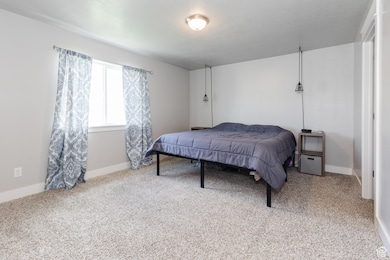 Carpeted bedroom featuring baseboards