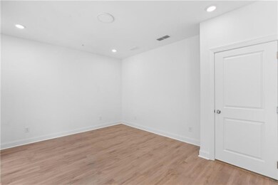 Spacious terrace-level media room offers a comfortable retreat for movie nights, gaming, or casual entertaining.