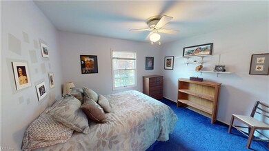 Bedroom 2: Carpeted bedroom featuring ceiling fan