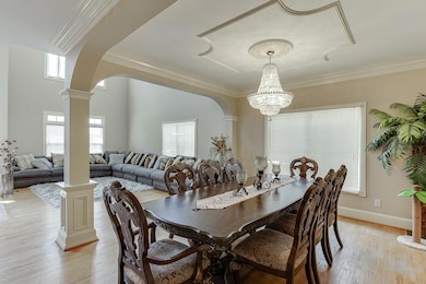 Dining room with decorative columns, arched walkwa