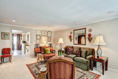 Spacious living area with neutral paint, plantatio