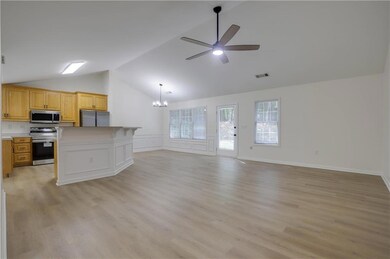 Unfurnished living room featuring lofted ceiling, 
