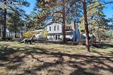 Rear view of property featuring a wooden deck and 