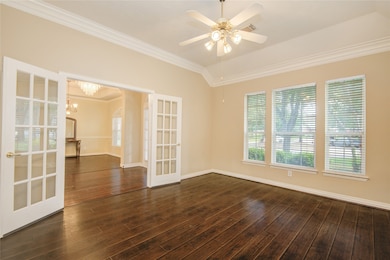 French doors open the study to the foyer, creating a flexible work-from-home space filled with natural light and elegant architectural detail.
