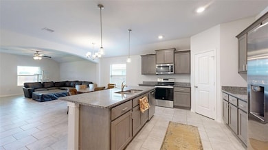 Kitchen featuring stainless steel appliances, a si
