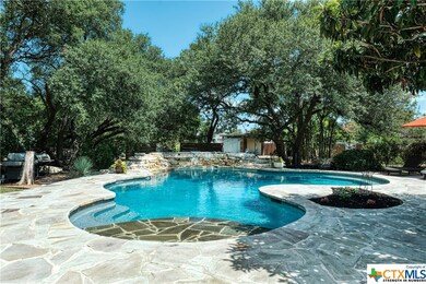 Beautiful 32,000 gallon heated pool with upgraded pool pump and floor cleaner, surrounded by flagstone patio and mature trees to help provide shade on those hot summer days.