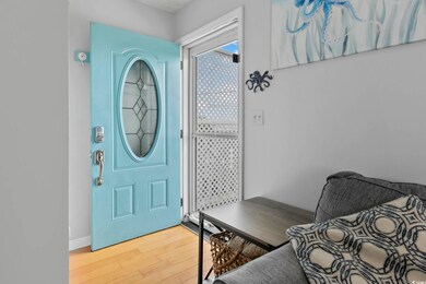 Entrance foyer with light wood-type flooring and baseboards