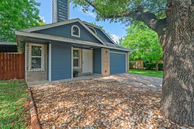 View of front of house with brick siding, an atta