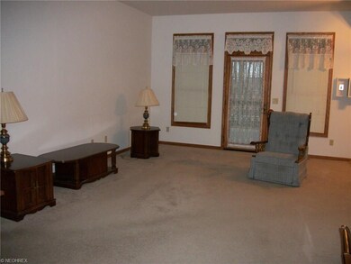 Formal living room and door to enter onto large co
