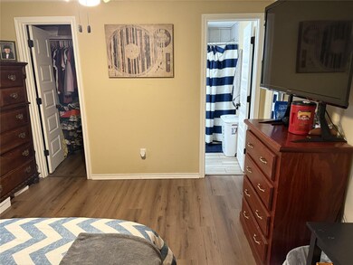 Bedroom with a closet, baseboards, connected bath