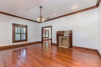 Large living area, with fireplace and wood floors,