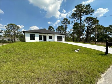 View of front of house with concrete driveway, a g