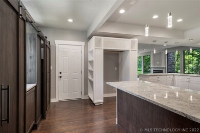 Exit to garage, Barn Door Pantry and Storage on le