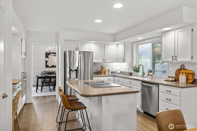 Fresh painted cabinetry, new hardware, stainless appliances, and abundant storage.