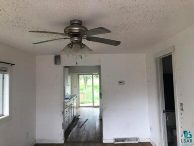 Spare room featuring dark wood-type flooring, a te