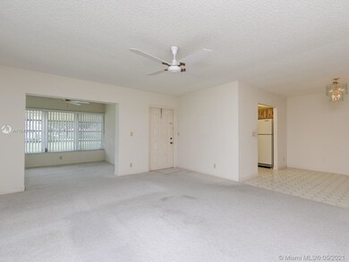 Entryway, den, living area, and dining area