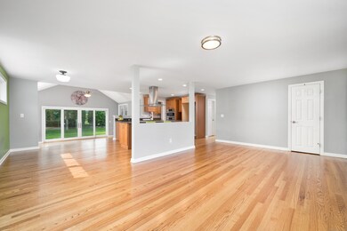Look into gorgeous open concept kitchen with the hood as the centerpiece