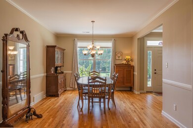 Dining area with ornamental molding, a chandelier,