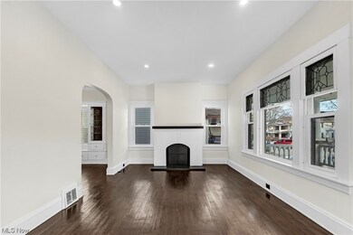 Unfurnished living room with dark wood-type flooring