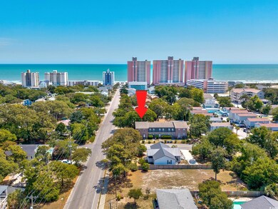 Birds eye view of property with a water view and a