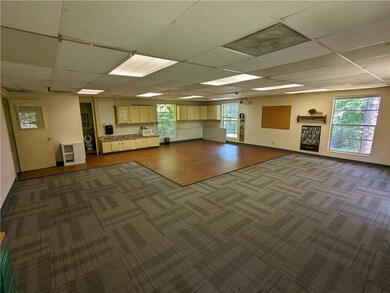 Miscellaneous room with dark colored carpet and a paneled ceiling