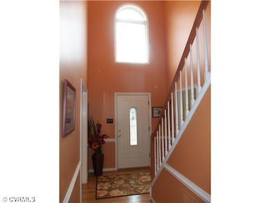 Foyer - Ornate front door, wood floors & accent wi