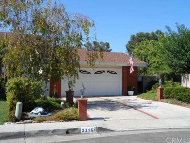 Front of home with walk way to park on the side.