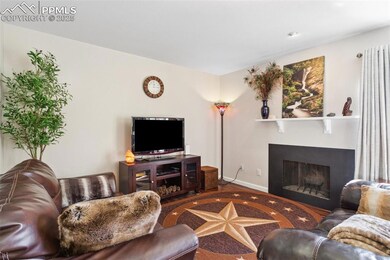Living room featuring a fireplace, baseboards, and