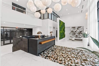 Welcome area featuring a towering ceiling, recessed lighting, and french doors