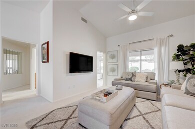 Living area with high vaulted ceiling, ceiling fan