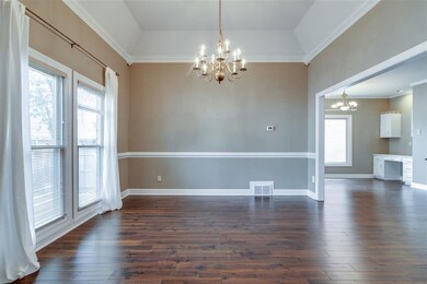 Spacious dining room with coffered ceilings opens 
