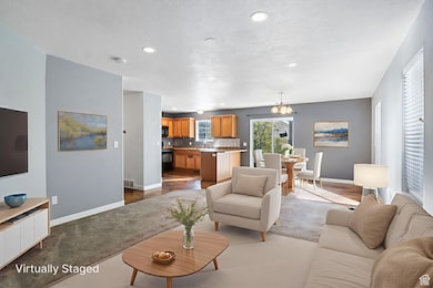 Living area featuring a chandelier, recessed lighting, and light wood finished floors