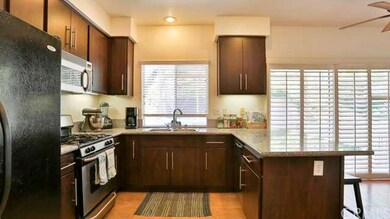 Beautiful Granite, Dark Cabinets with Modern Hardw