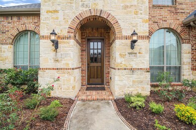 Inviting Front entry is all brick and stone. Rich Front Door and Covered Porch.