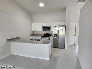 Kitchen featuring stainless steel appliances, a pe