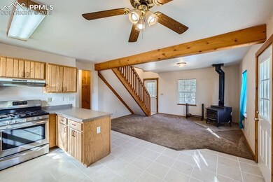 Kitchen with beamed ceiling, kitchen peninsula, li